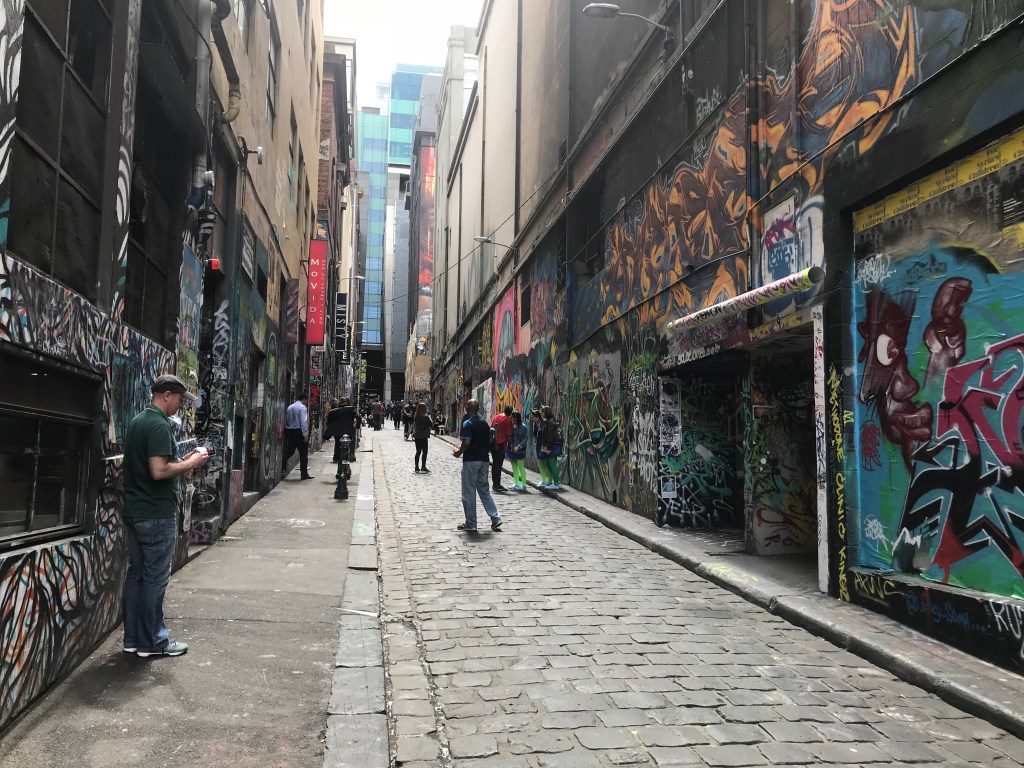 People looking at street art in Hosier Lane, Melbourne.
