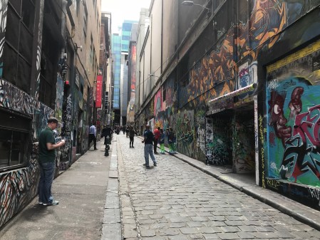 People looking at street art in Hosier Lane, Melbourne.